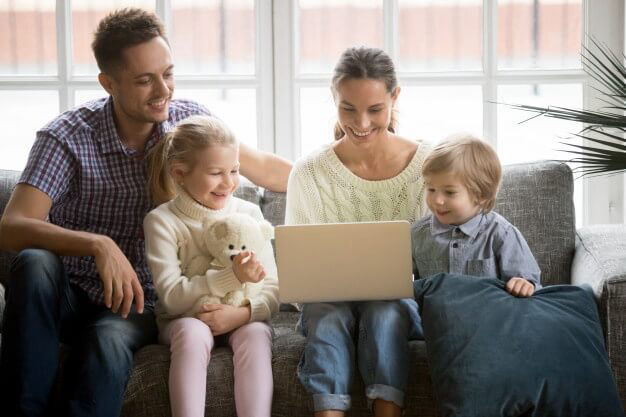 happy-family-with-children-having-fun-using-laptop-sofa